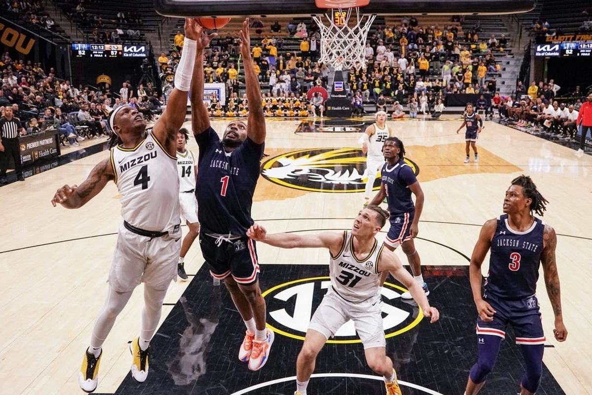 Missouri Tigers guard Curt Lewis (4) shoots a layup as Jackson State Tigers forward Zeke Cook (1) defends during the second half at Mizzou Arena.