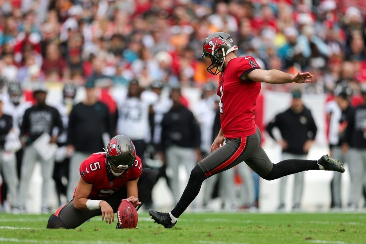Dec 24, 2023; Tampa, Florida, USA;  Tampa Bay Buccaneers place kicker Chase McLaughlin (4) kicks a field goal held by punter Jake Camarda (5) against the Jacksonville Jaguars in the first quarter at Raymond James Stadium.