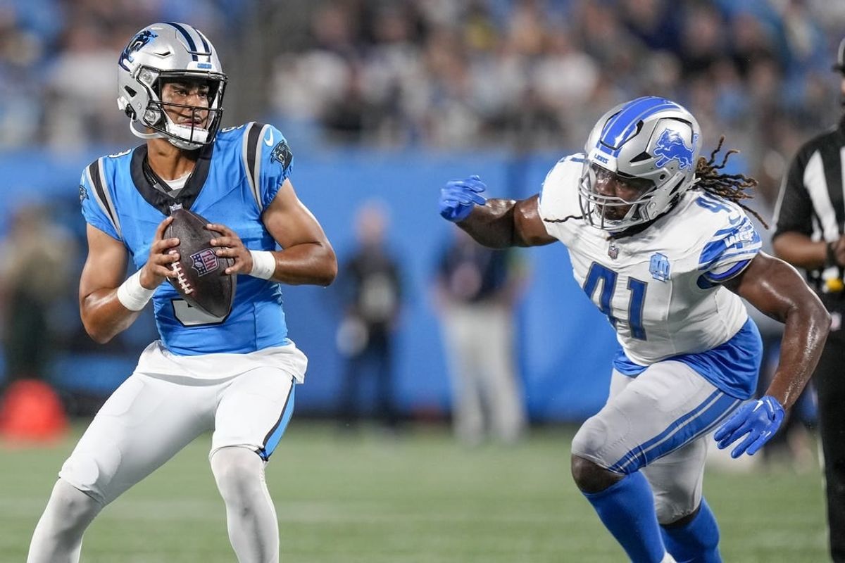 Aug 25, 2023; Charlotte, North Carolina, USA; Carolina Panthers quarterback Bryce Young (9) drops back under pressure from Detroit Lions linebacker James Houston (41) during the first quarter at Bank of America Stadium.