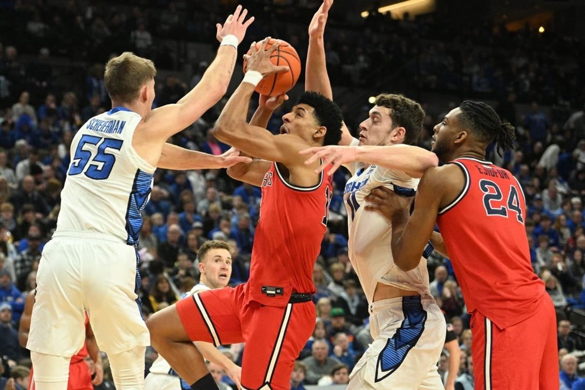 Jan 13, 2024; Omaha, Nebraska, USA;  Creighton Bluejays guard Baylor Scheierman (55) and center Ryan Kalkbrenner (11) defend against St. John's Red Storm guard RJ Luis Jr. (12) in the first half at CHI Health Center Omaha.