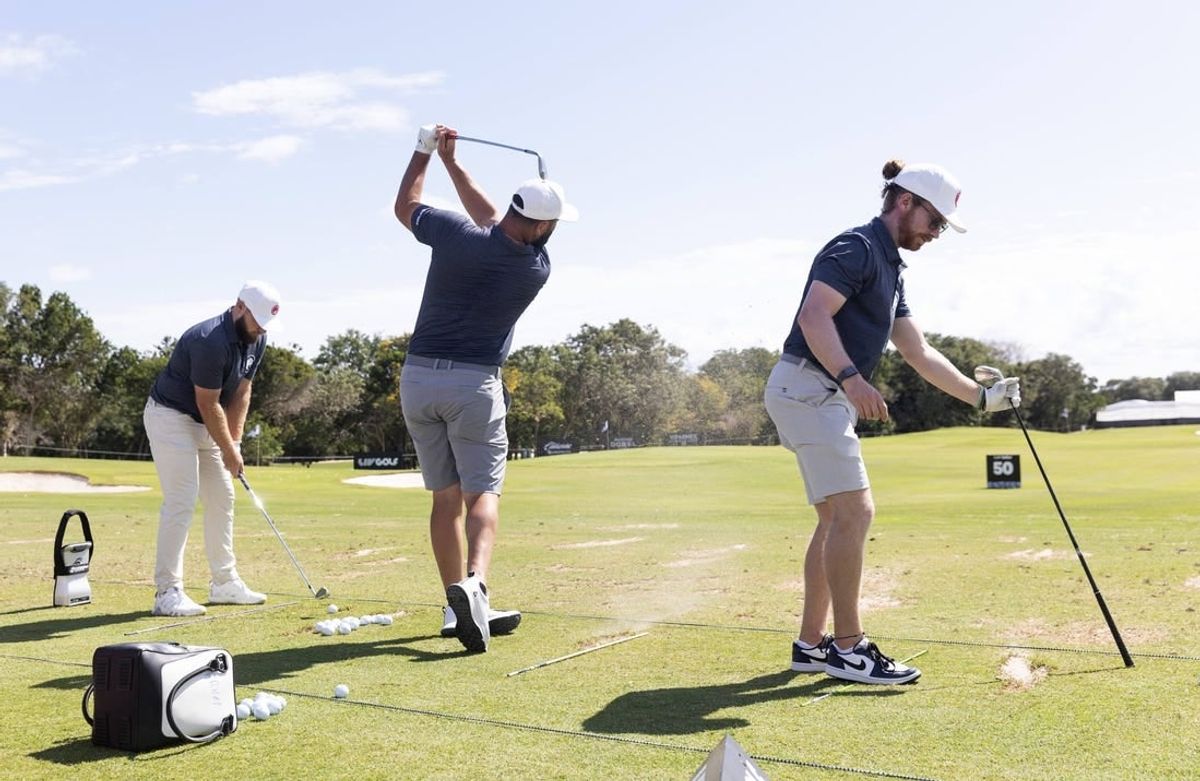 Feb 2, 2024; Playa del Carmen, Quintana Roo, MEX; Jon Rahm of Team Legion XIII, center, hits on the practice range with teammates Tyrrell Hatton, left, and Kieran Vincent before the first round of the LIV Golf Mayakoba tournament at El Chamaleon Golf Course.
