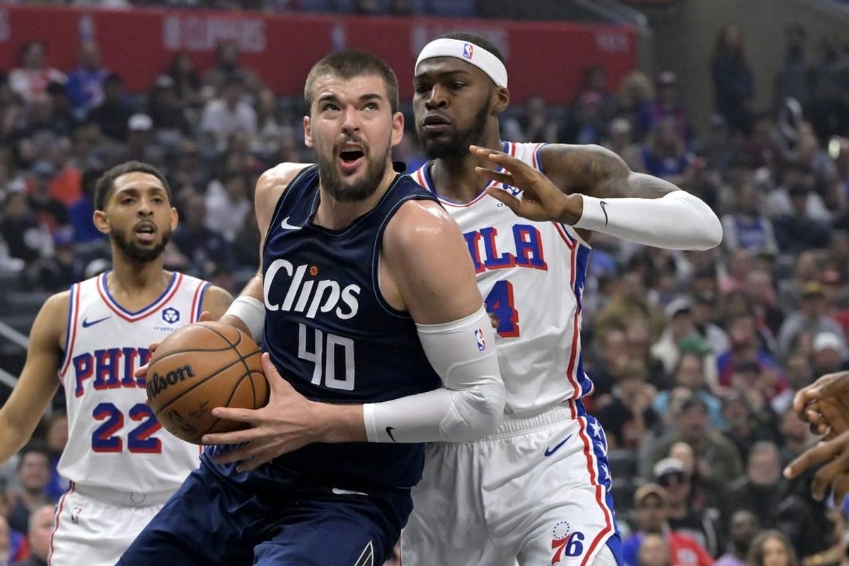 Mar 24, 2024; Los Angeles, California, USA;  Los Angeles Clippers center Ivica Zubac (40) is defended by Philadelphia 76ers forward Paul Reed (44) as he drives to the basket in the first half at Crypto.com Arena.