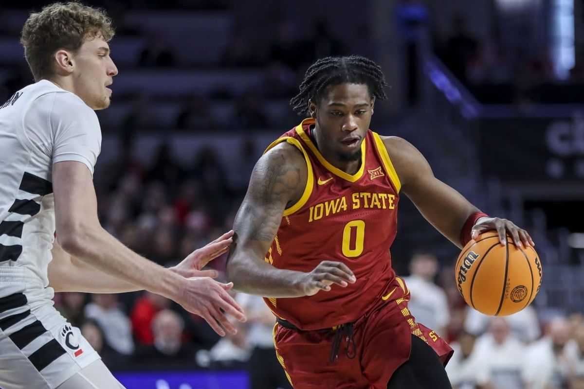 Feb 13, 2024; Cincinnati, Ohio, USA; Iowa State Cyclones forward Tre King (0) dribbles against Cincinnati Bearcats forward Viktor Lakhin (30) in the first half at Fifth Third Arena.