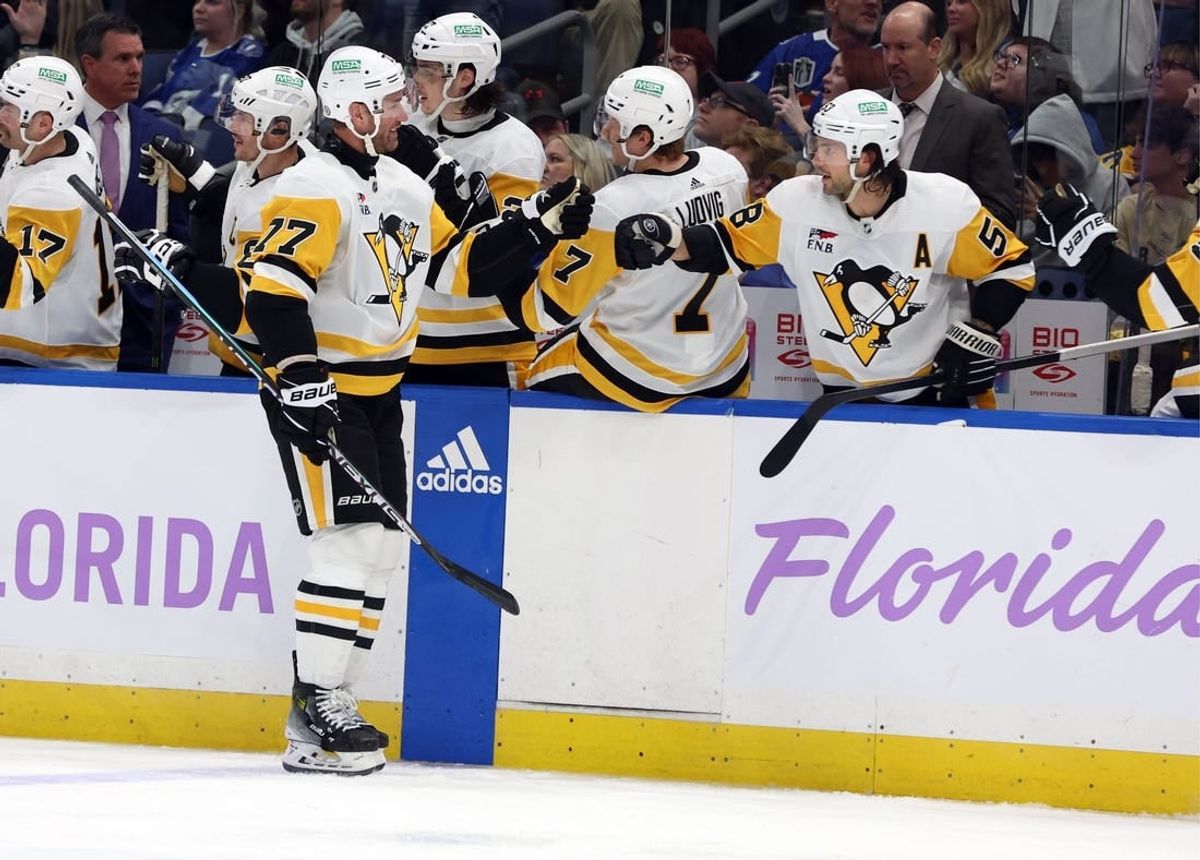 Nov 30, 2023; Tampa, Florida, USA; Pittsburgh Penguins center Jeff Carter (77) is congratulated after he scored a goal against the Tampa Bay Lightning during the third period at Amalie Arena.
