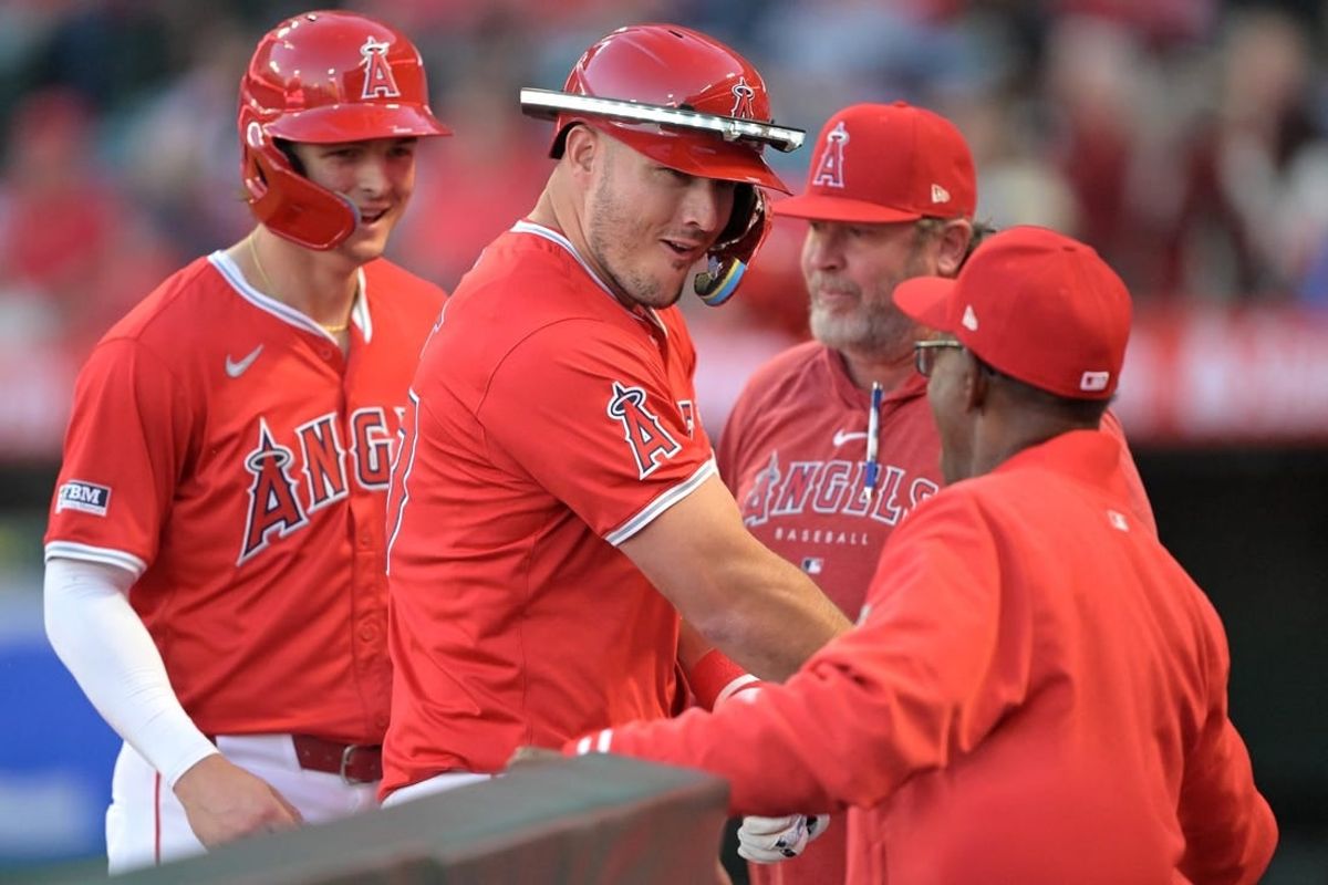 Apr 9, 2024; Anaheim, California, USA;  Los Angeles Angels outfielder Mike Trout (27) celebrates in the dugout after hitting a two run home run in the first inning against the Tampa Bay Rays at Angel Stadium.