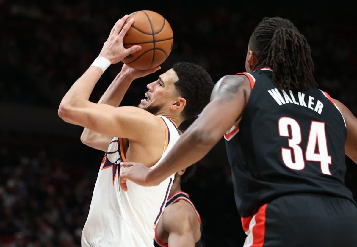 Jan 14, 2024; Portland, Oregon, USA;  Phoenix Suns guard Devin Booker (1) shoots the ball over Portland Trail Blazers forward Jabari Walker (34) in the third quarter at Moda Center.