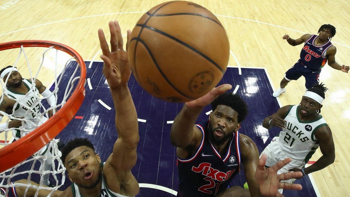 Giannis  Antetokounmpo  and Joel Embiid battle for the ball Tuesday night in Philly.