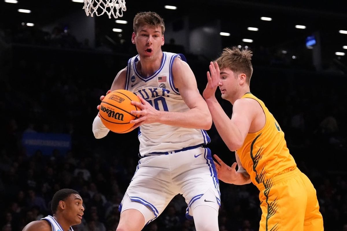 Mar 22, 2024; Brooklyn, NY, USA; Duke Blue Devils center Kyle Filipowski (30) grabs a rebound against the Vermont Catamounts in the first round of the 2024 NCAA Tournament at the Barclays Center.
