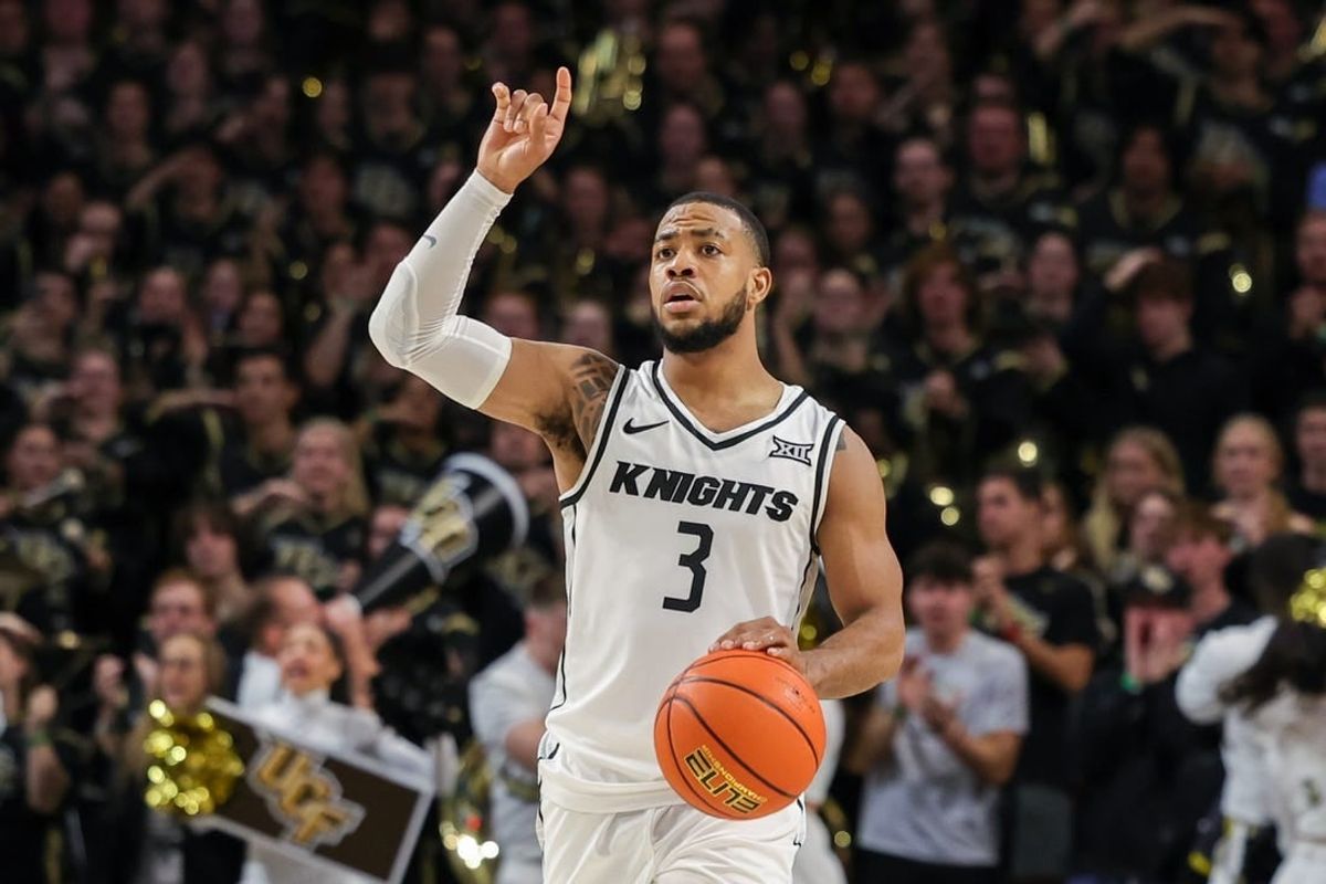 Jan 10, 2024; Orlando, Florida, USA; UCF Knights guard Darius Johnson (3) signals to teammates as he brings the ball up court during the second half against the Kansas Jayhawks at Addition Financial Arena.
