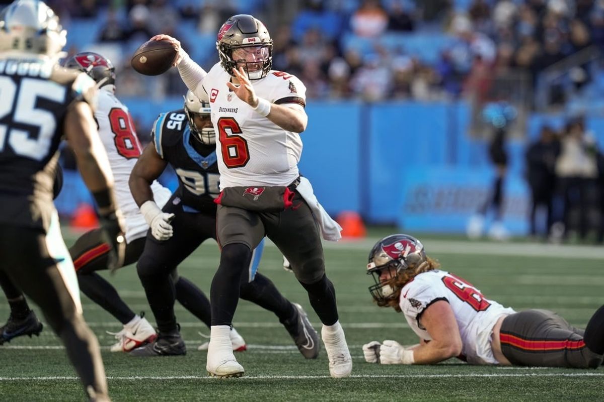 Jan 7, 2024; Charlotte, North Carolina, USA;  Tampa Bay Buccaneers quarterback Baker Mayfield (6) makes a throw against  Carolina Panthers defensive tackle Derrick Brown (95) during the second half at Bank of America Stadium.