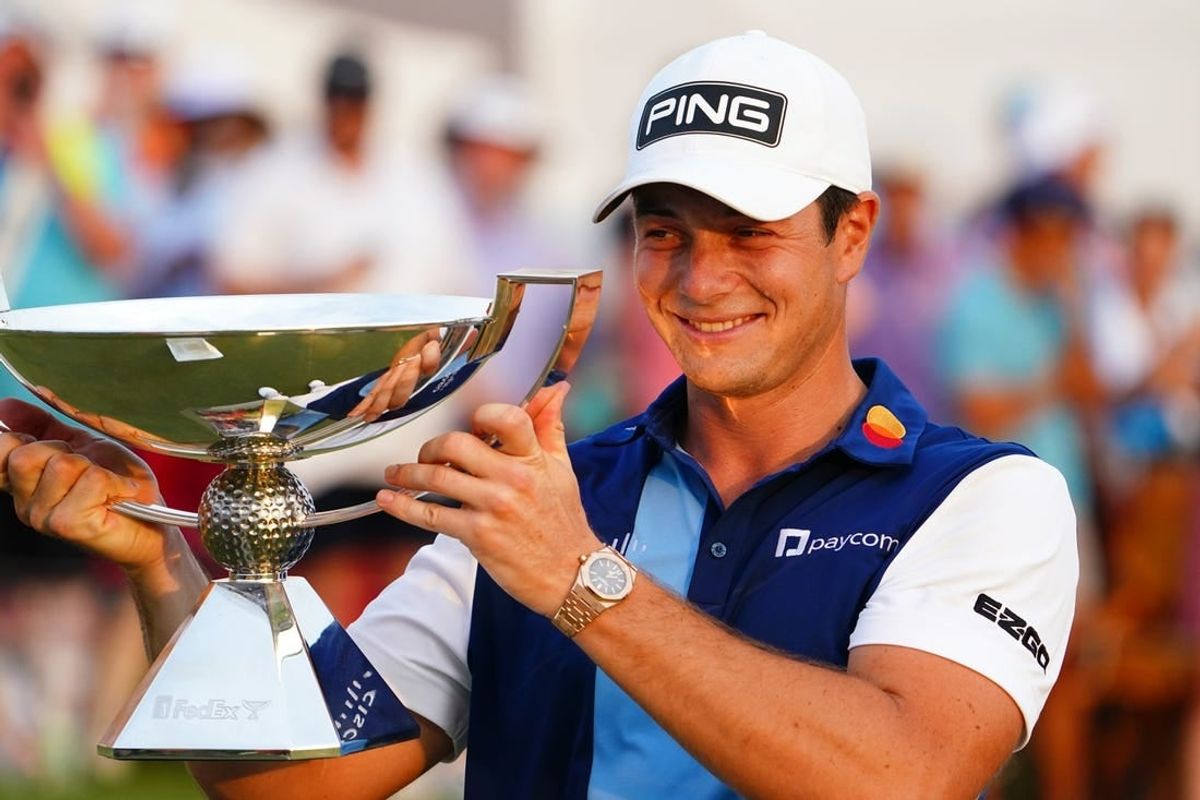 Aug 27, 2023; Atlanta, Georgia, USA; Viktor Hovland celebrate with the FedEx trophy after winning the TOUR Championship golf tournament at East Lake Golf Club.