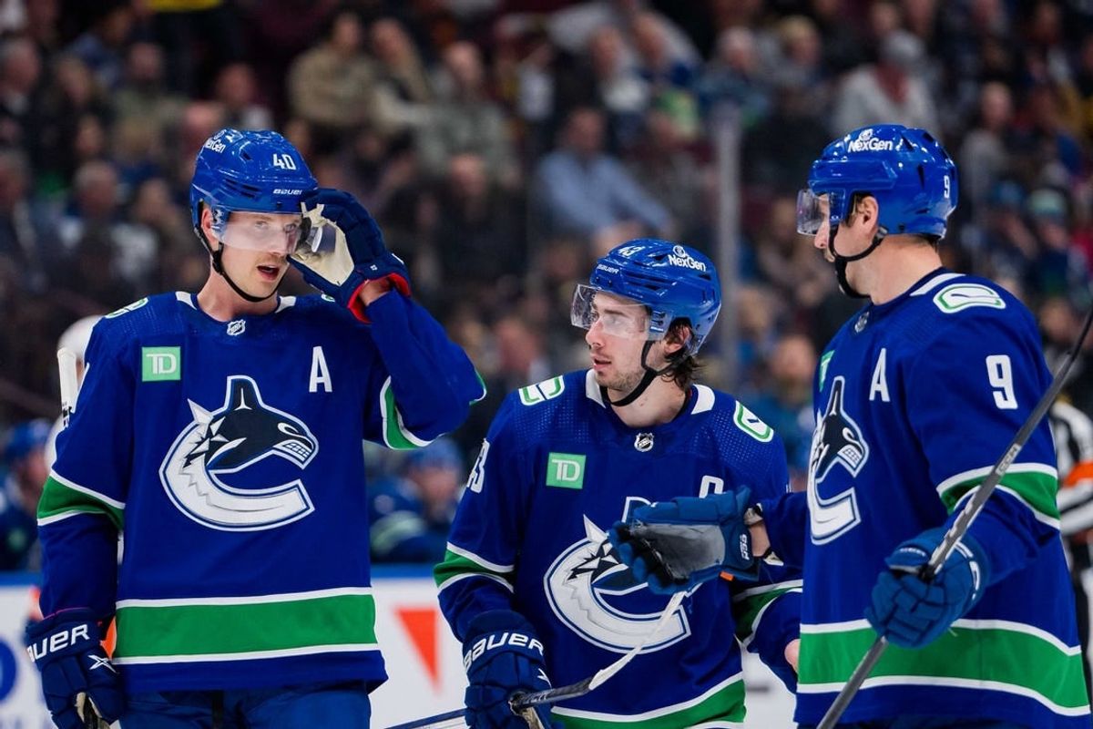 Nov 15, 2023; Vancouver, British Columbia, CAN; Vancouver Canucks forward Elias Pettersson (40) and defenseman Quinn Hughes (43) and forward J.T. Miller (9) discuss face off strategy against the New York Islanders in the third period at Rogers Arena. Vancouver won 4-3 in overtime.