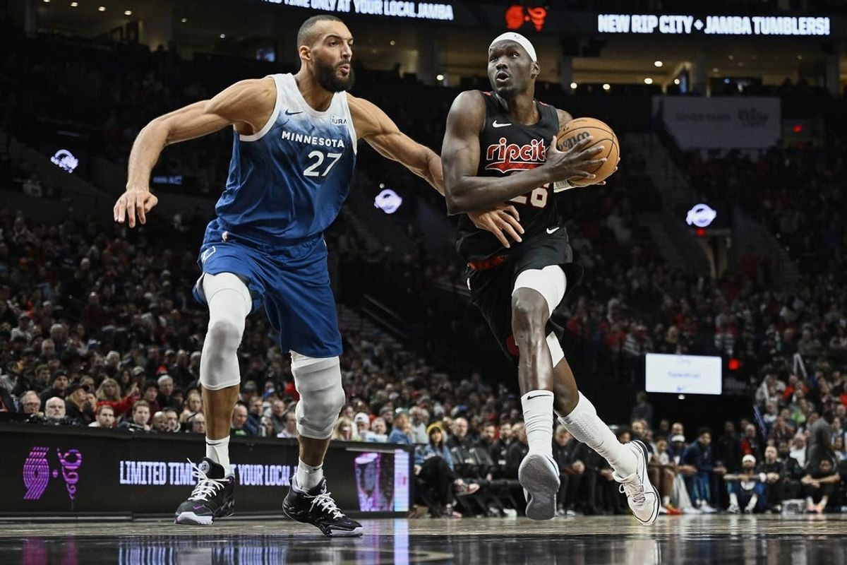 Feb 15, 2024; Portland, Oregon, USA; Portland Trail Blazers center Duop Reath (26) drives to the basket during the second half against Minnesota Timberwolves center Rudy Gobert (27) at Moda Center.