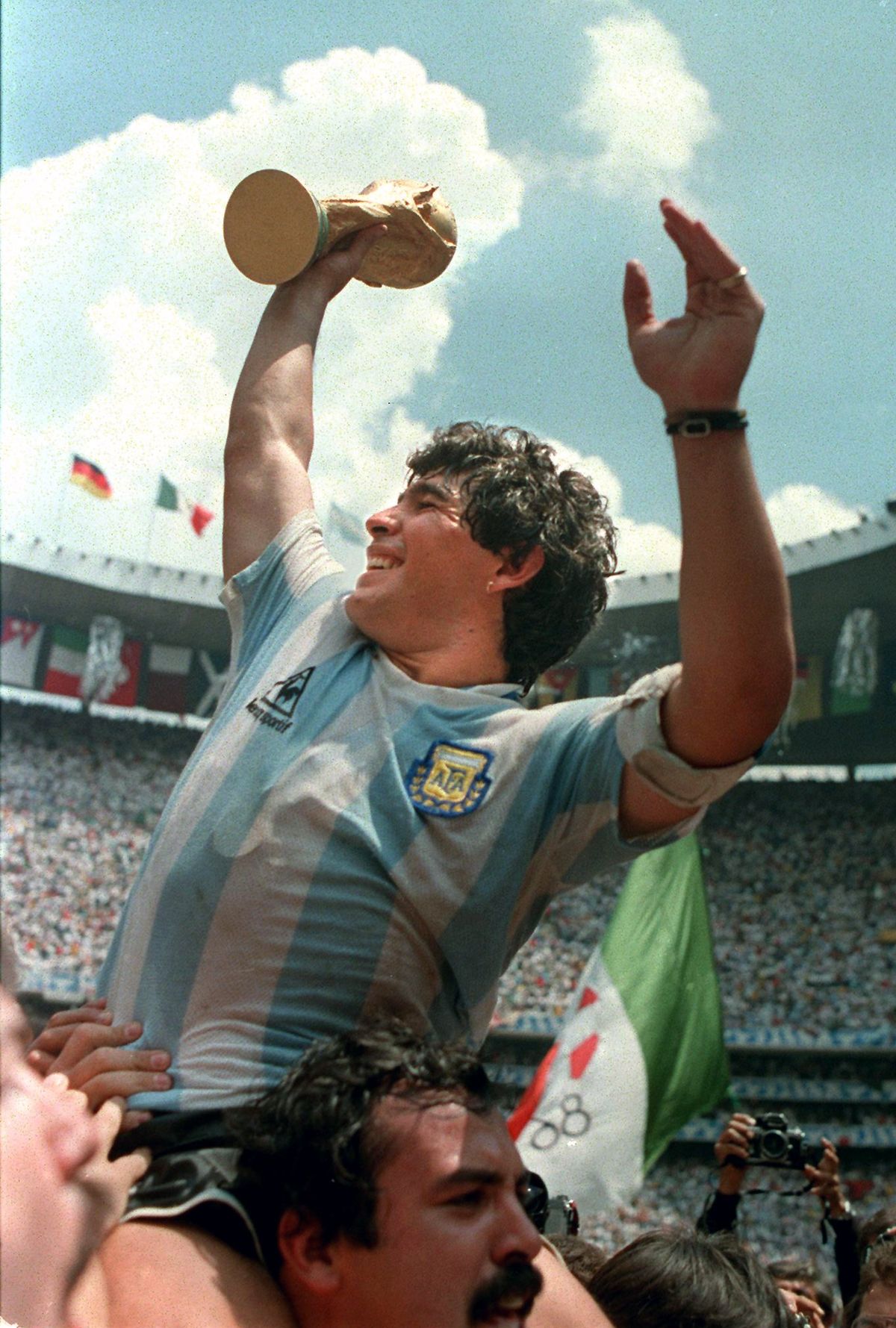 Maradona holds up World Cup trophy in 1986.