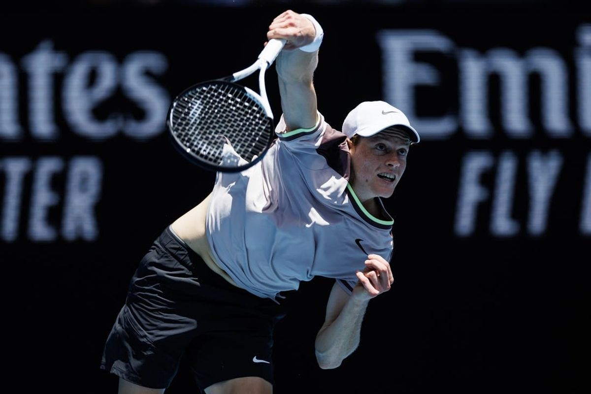 Jan 14, 2024; Melbourne, Victoria, Australia;   Jannik Sinner of Italy hits a shot against Botic Van De Zandschulp of the Netherlands in the first round of the men s singles.