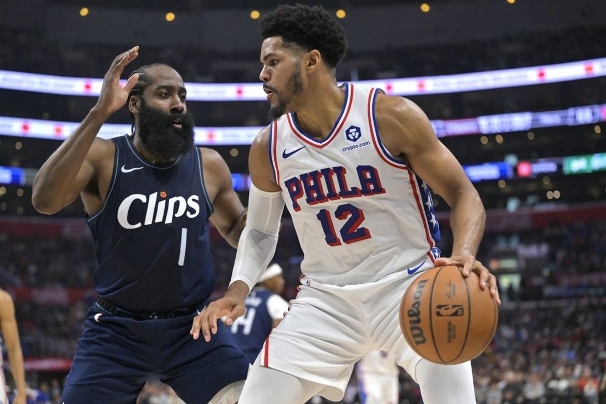 Mar 24, 2024; Los Angeles, California, USA;   Philadelphia 76ers forward Tobias Harris (12) is defended by Los Angeles Clippers guard James Harden (1) in the second half at Crypto.com Arena.