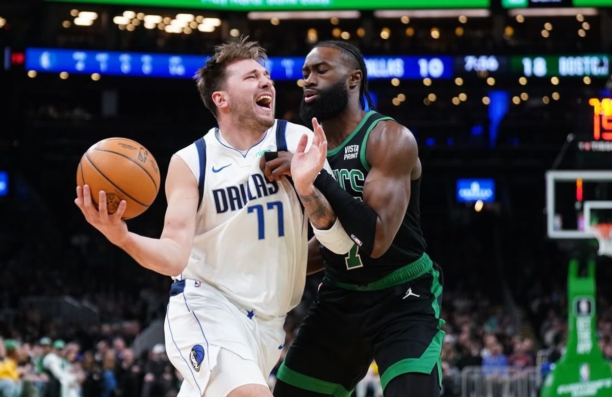 Mar 1, 2024; Boston, Massachusetts, USA; Dallas Mavericks guard Luka Doncic (77) drives the ball against Boston Celtics guard Jaylen Brown (7) in the first quarter at TD Garden.