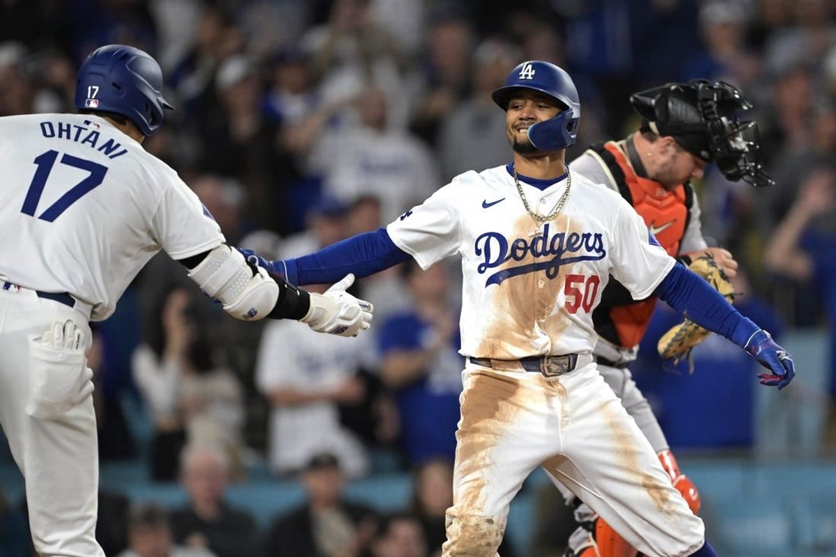 Apr 2, 2024; Los Angeles, California, USA; Los Angeles Dodgers shortstop Mookie Betts (50) is congratulated by designated hitter Shohei Ohtani (17) after hitting a solo home run for his 1500th career hit in the third inning against the San Francisco Giants at Dodger Stadium.