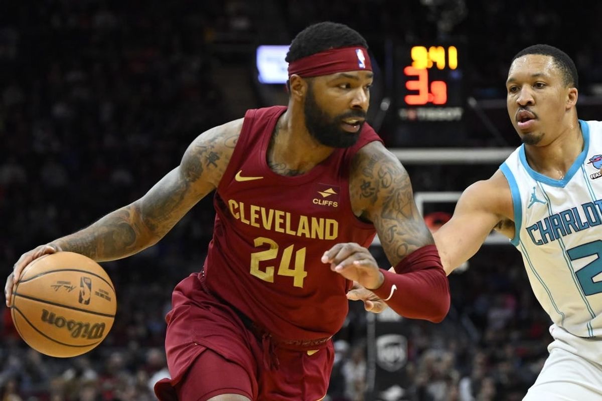 Mar 25, 2024; Cleveland, Ohio, USA; Cleveland Cavaliers forward Marcus Morris Sr. (24) dribbles beside Charlotte Hornets forward Grant Williams (2) in the second quarter at Rocket Mortgage FieldHouse.