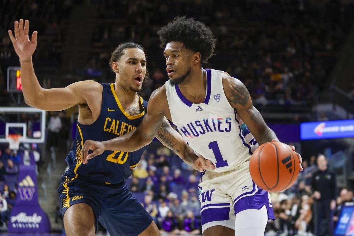 Feb 17, 2024; Seattle, Washington, USA; Washington Huskies forward Keion Brooks Jr. (1) dribbles against California Golden Bears guard Jaylon Tyson (20) during the first half at Alaska Airlines Arena at Hec Edmundson Pavilion.