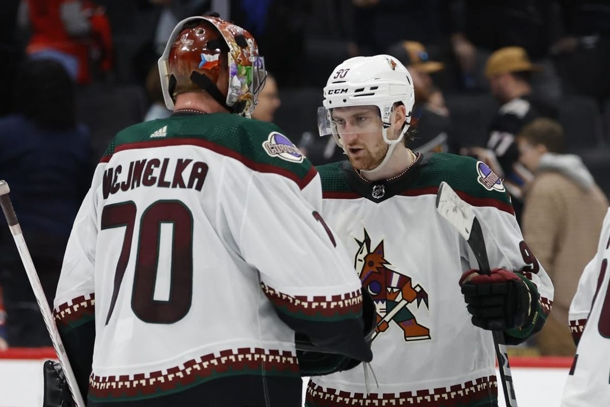 Mar 3, 2024; Washington, District of Columbia, USA; Arizona Coyotes goaltender Karel Vejmelka (70) celebrates with Coyotes defenseman J.J. Moser (90) after their game against the Washington Capitals at Capital One Arena.