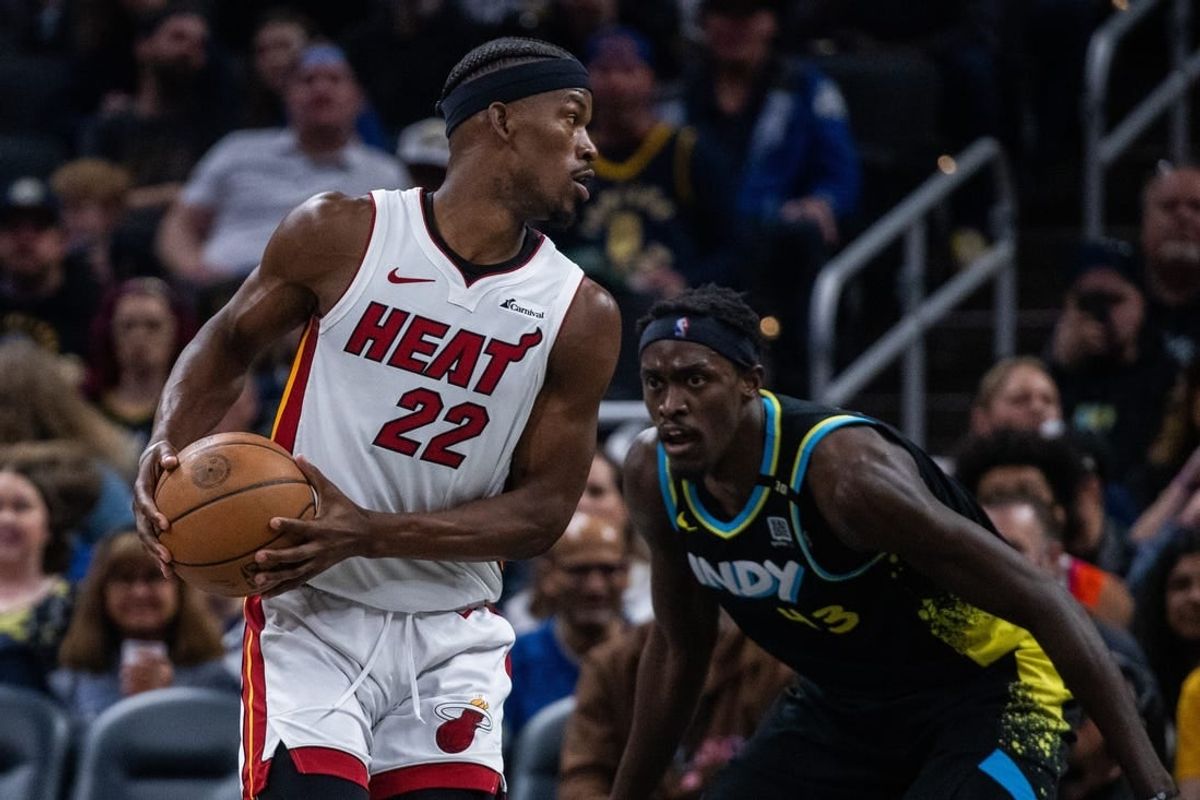 Apr 7, 2024; Indianapolis, Indiana, USA;  Miami Heat forward Jimmy Butler (22) holds the ball while Indiana Pacers forward Pascal Siakam (43) defends in the first half at Gainbridge Fieldhouse.