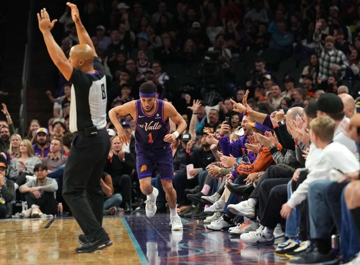 Dec 29, 2023; Phoenix, Arizona, USA; Phoenix Suns guard Devin Booker (1) celebrates a three point basket against the Charlotte Hornets during the first half at Footprint Center.