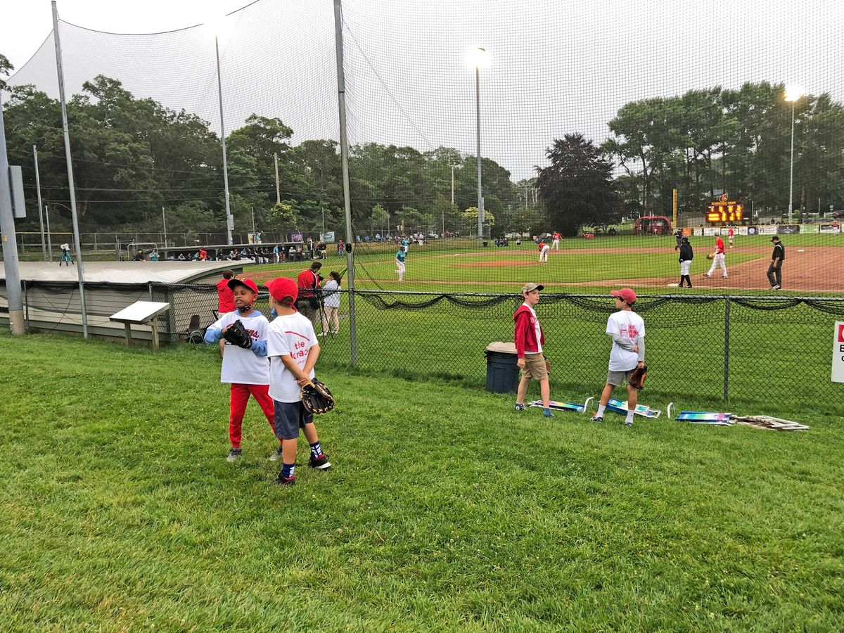 Kids dressed in Orleans Firebirds colors  organize their own game along the first- base line at Eldredge Park .