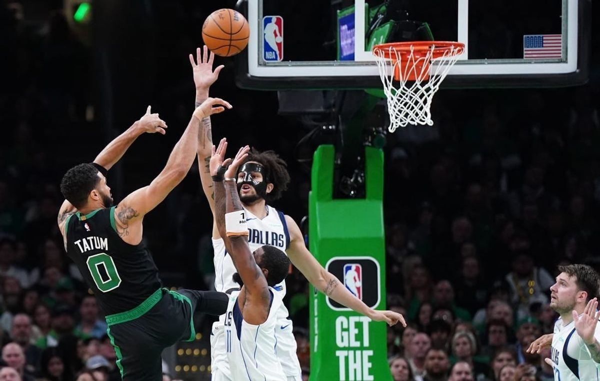 Mar 1, 2024; Boston, Massachusetts, USA; Dallas Mavericks center Dereck Lively II (2) and guard Kyrie Irving (11) defend against Boston Celtics forward Jayson Tatum (0) in the second quarter at TD Garden.