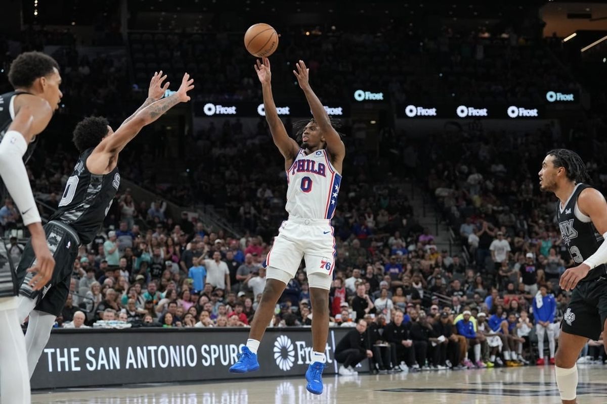 Apr 7, 2024; San Antonio, Texas, USA;  Philadelphia 76ers guard Tyrese Maxey (0) shoots over San Antonio Spurs forward Julian Champagnie (30) in overtime at Frost Bank Center.