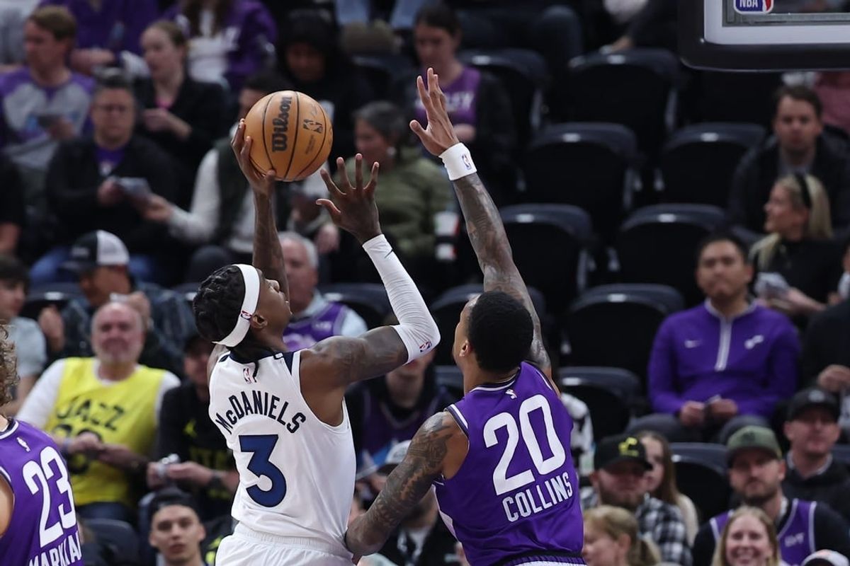 Mar 18, 2024; Salt Lake City, Utah, USA; Minnesota Timberwolves forward Jaden McDaniels (3) goes to the basket against Utah Jazz forward John Collins (20) during the first quarter at Delta Center.