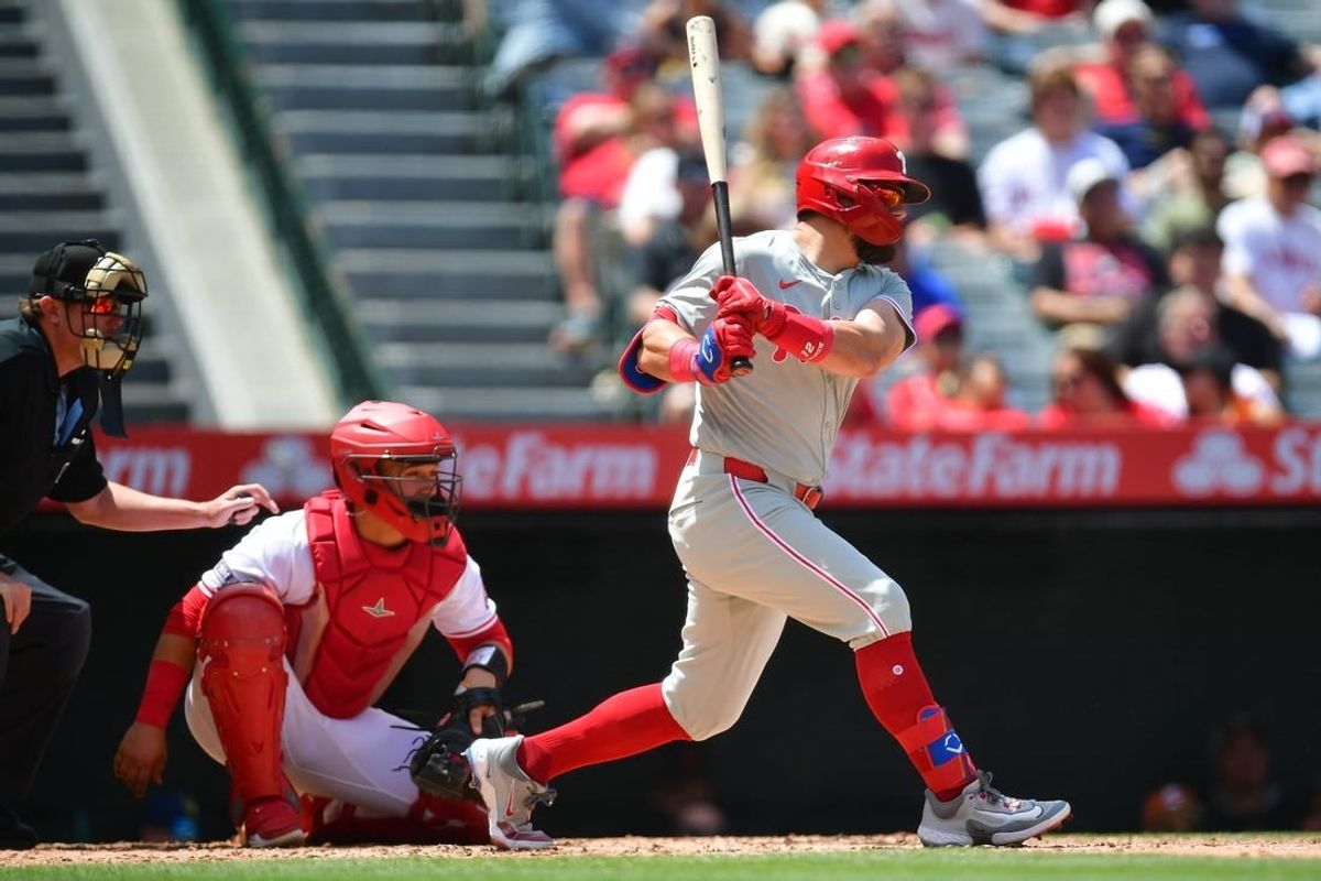 May 1, 2024; Anaheim, California, USA; Philadelphia Phillies left fielder Kyle Schwarber (12) hits a two run RBI single against the Los Angeles Angels during the second inning at Angel Stadium.