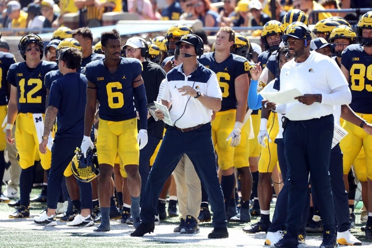 Outgoing head coach Jim Harbaugh endorsed offensive coordinator Sherrone Moore, right, as the next coach of the Wolverines.