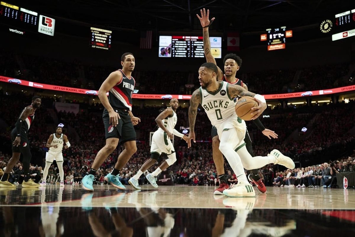 Jan 31, 2024; Portland, Oregon, USA; Milwaukee Bucks guard Damian Lillard (0) drives to the basket during the first half against Portland Trail Blazers guard Anfernee Simons (1) at Moda Center.