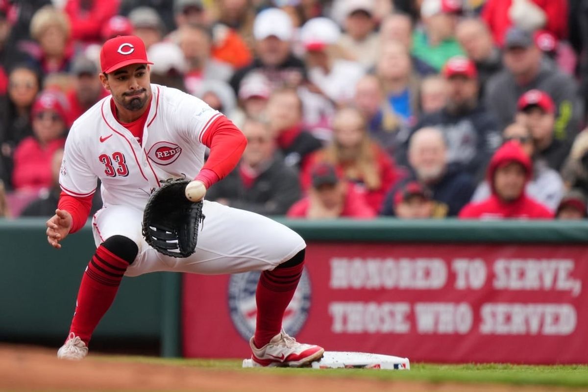 Cincinnati Reds first base Christian Encarnacion-Strand (33) receives a throw for an out in the first inning of a baseball game against the Los Angeles Angels, Sunday, April 21, 2024, at Great American Ball Park in Cincinnati.
