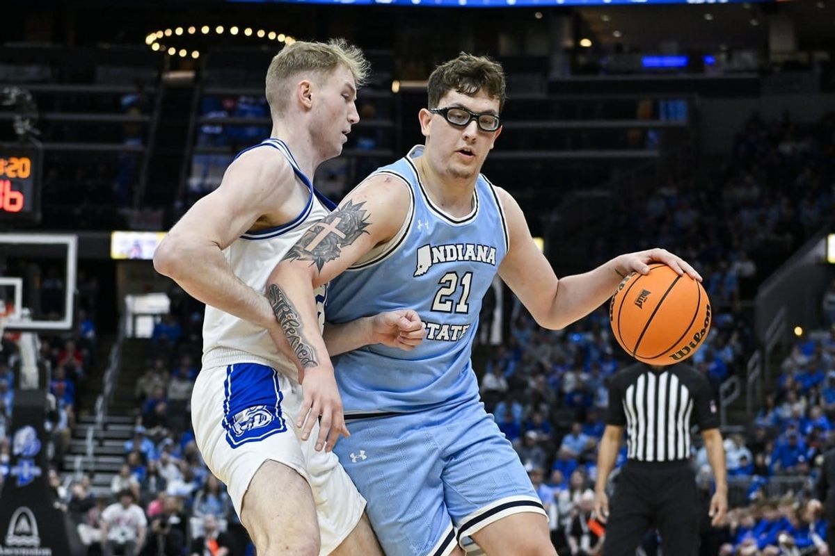 Mar 10, 2024; St. Louis, MO, USA;  Indiana State Sycamores center Robbie Avila (21) drives to the basket as Drake Bulldogs forward Nate Ferguson (24) defends during the first half of the Missouri Valley Conference Tournament Championship game at Enterprise Center.