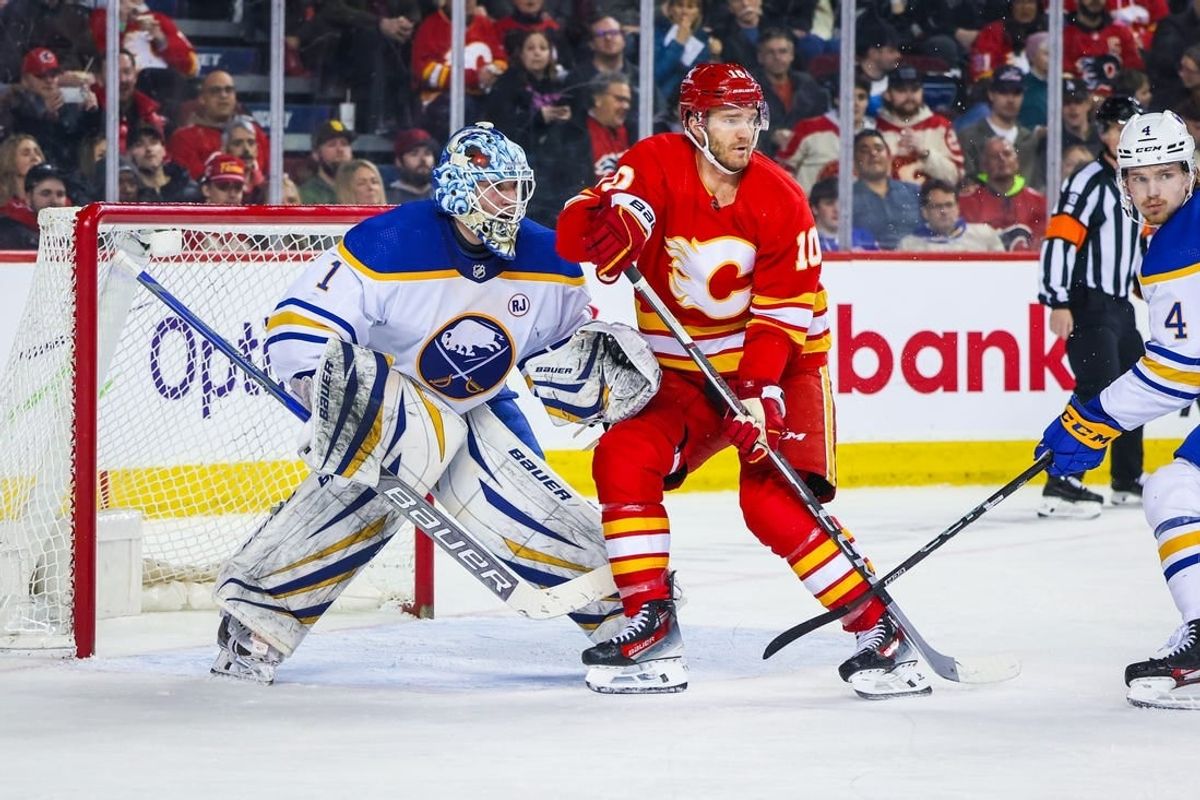 Mar 24, 2024; Calgary, Alberta, CAN; Calgary Flames center Jonathan Huberdeau (10) screens in front of Buffalo Sabres goaltender Ukko-Pekka Luukkonen (1) during the second period at Scotiabank Saddledome.