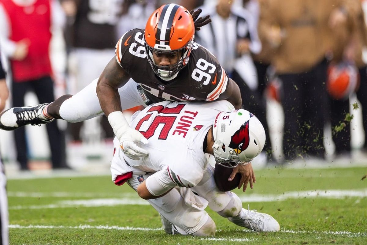Nov 5, 2023; Cleveland, Ohio, USA; Cleveland Browns defensive end Za'Darius Smith (99) sacks Arizona Cardinals quarterback Clayton Tune (15) during the fourth quarter at Cleveland Browns Stadium.