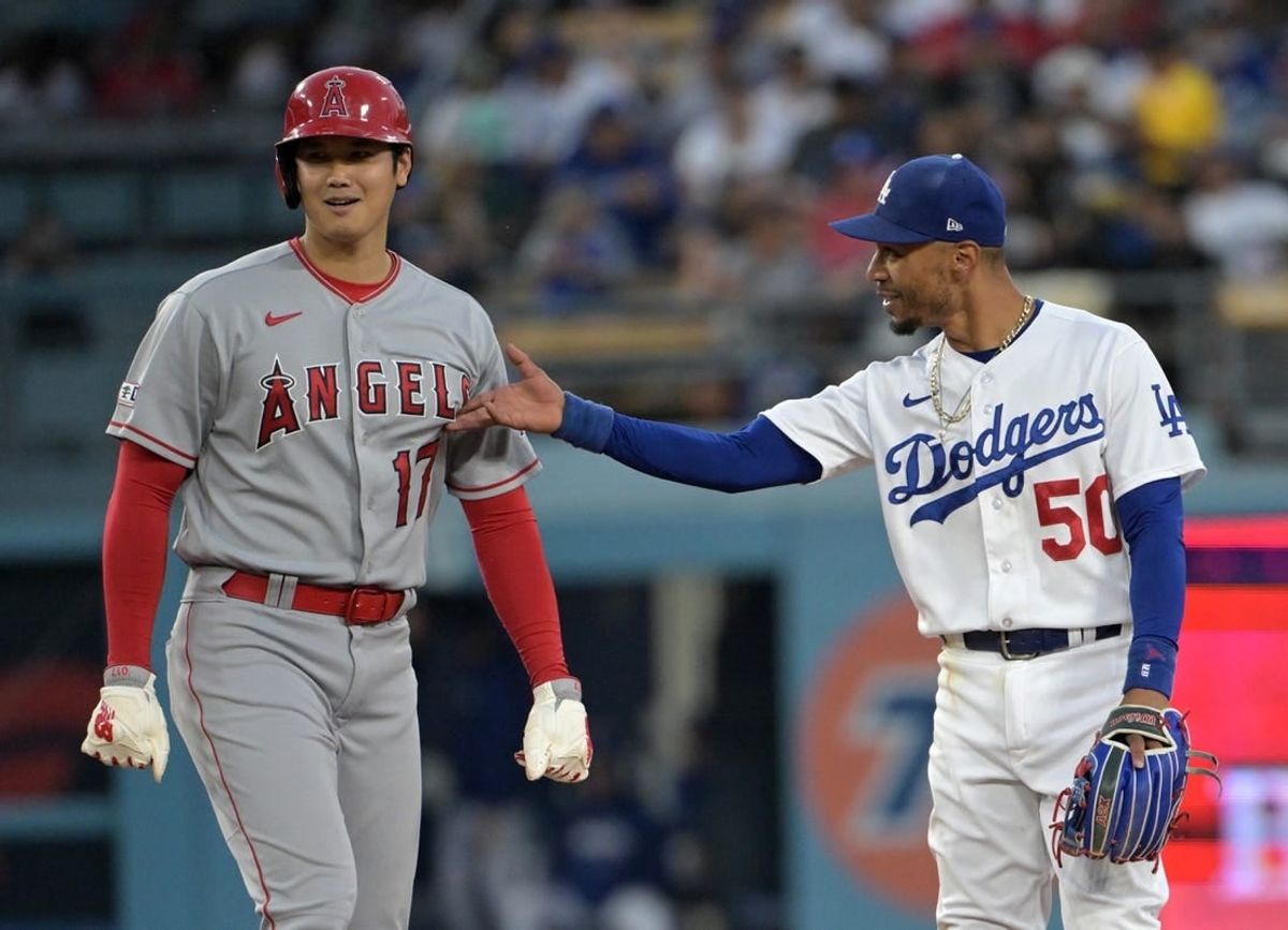 Jul 7, 2023; Los Angeles, California, USA; Los Angeles Angels starting pitcher Shohei Ohtani (17) and Los Angeles Dodgers right fielder Mookie Betts (50) talk while at second base during a play review in the fourth inning at Dodger Stadium.