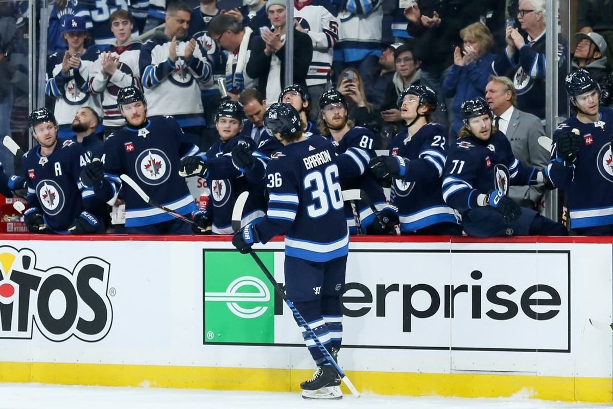 Dec 2, 2023; Winnipeg, Manitoba, CAN;  Winnipeg Jets forward Morgan Barron (36) is congratulated by his team mates on his goal against the Chicago Blackhawks during the second period at Canada Life Centre.