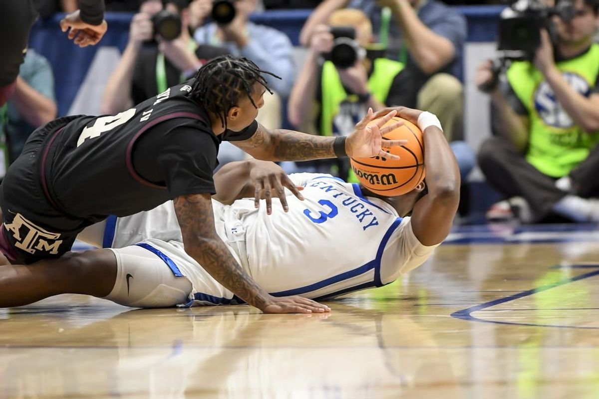 Mar 15, 2024; Nashville, TN, USA; Texas A&M Aggies guard Wade Taylor IV (4) and Kentucky Wildcats guard Adou Thiero (3) fight for the loose ball during the first half at Bridgestone Arena.