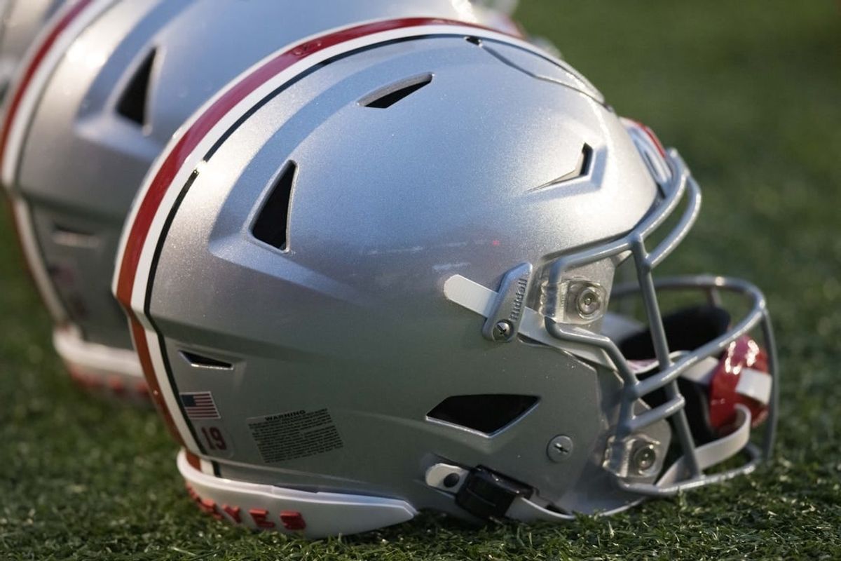 Oct 28, 2023; Madison, Wisconsin, USA;  Ohio State Buckeyes helmets sit on the field during warmups prior to the game against the Wisconsin Badgers at Camp Randall Stadium.
