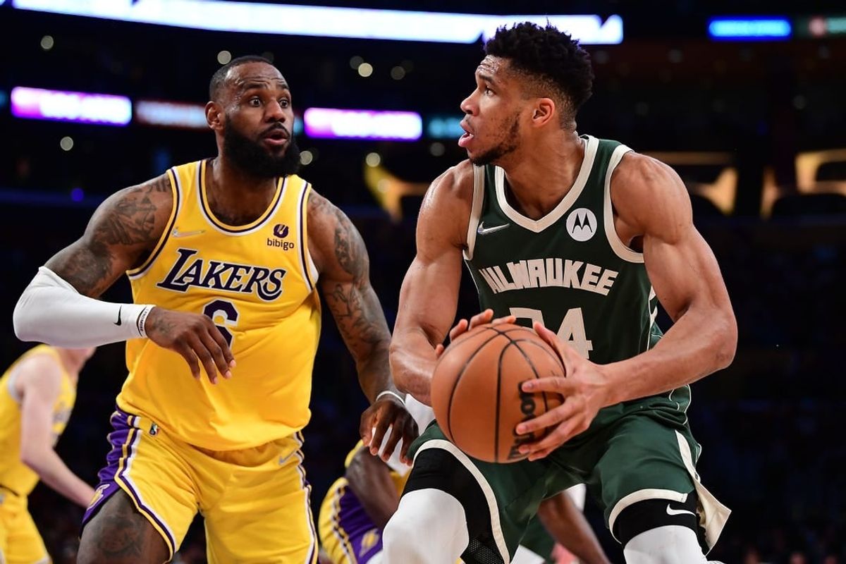 Feb 8, 2022; Los Angeles, California, USA; Milwaukee Bucks forward Giannis Antetokounmpo (34) moves the ball against Los Angeles Lakers forward LeBron James (6) during the second half at Crypto.com Arena.