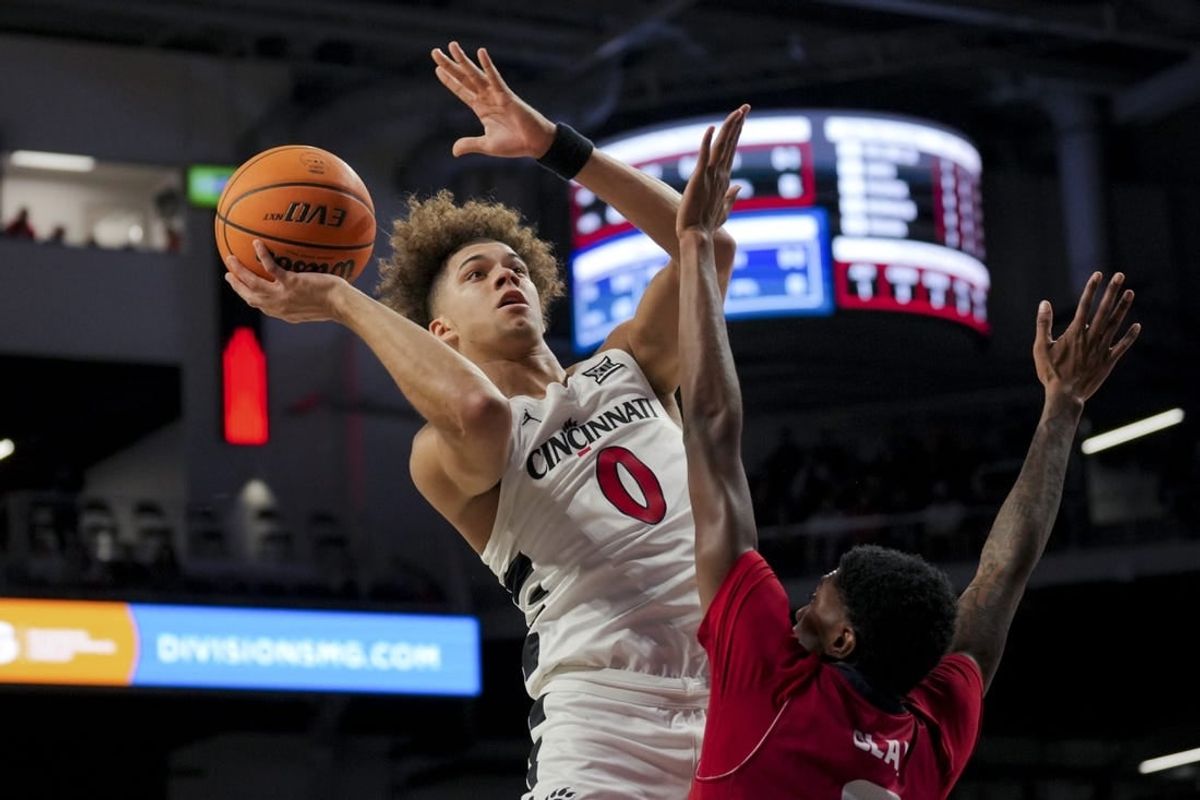 Nov 6, 2023; Cincinnati, Ohio, USA;  Cincinnati Bearcats guard Dan Skillings Jr. (0) drives to the basket against Illinois-Chicago Flames guard Steven Clay (2) in the first half at Fifth Third Arena.