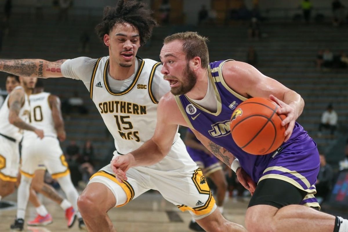 Jan 6, 2024; Hattiesburg, Mississippi, USA; James Madison Dukes guard Noah Freidel (1) drives on Southern Miss Golden Eagles guard Donovan Ivory (15) during the first half at Reed Green Coliseum.