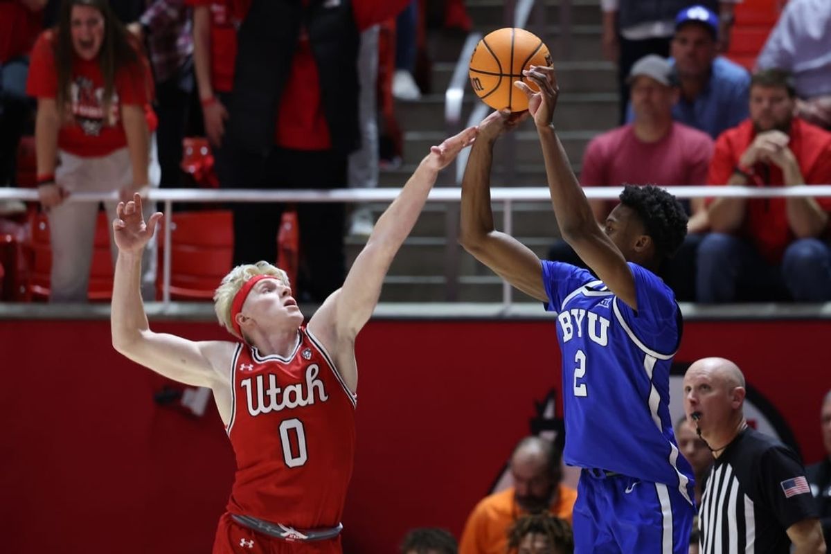 Dec 9, 2023; Salt Lake City, Utah, USA; Brigham Young Cougars guard Jaxson Robinson (2) is fouled by Utah Utes guard Hunter Erickson (0) shooting a three point shot during the second half at Jon M. Huntsman Center.