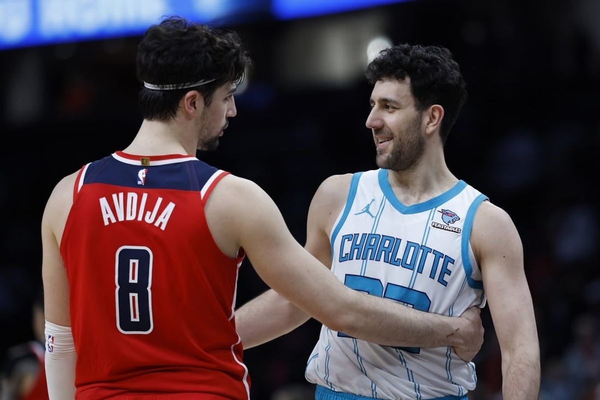 Mar 8, 2024; Washington, District of Columbia, USA; Washington Wizards forward Deni Avdija (8) hugs Charlotte Hornets guard Vasa Micic (22) after their game at Capital One Arena.
