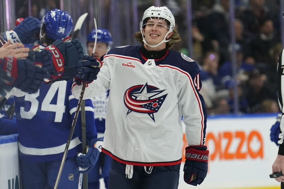 Dec 14, 2023; Toronto, Ontario, CAN; Columbus Blue Jackets forward Kent Johnson (91) gets congratulated after scoring against the Toronto Maple Leafs during the first period at Scotiabank Arena.