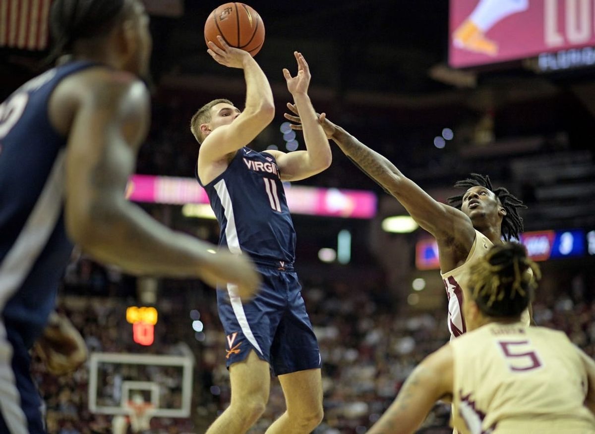 Feb 10, 2024; Tallahassee, Florida, USA; Virginia Cavaliers guard Isaac McKneely (11) shoots the ball over Florida State Seminoles forward Jamir Watkins (2) during the first half at Donald L. Tucker Center.