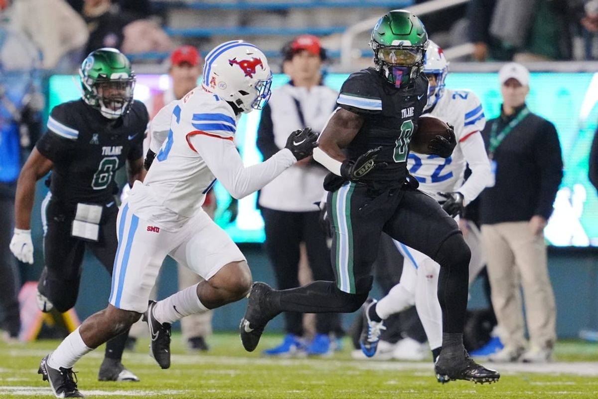 Nov 17, 2022; New Orleans, Louisiana, USA; Tulane Green Wave running back Shaadie Clayton-Johnson (0) runs the ball against the Southern Methodist Mustangs during the second half at Yulman Stadium.